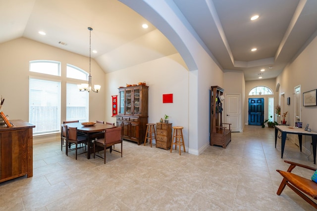 dining room with vaulted ceiling and an inviting chandelier