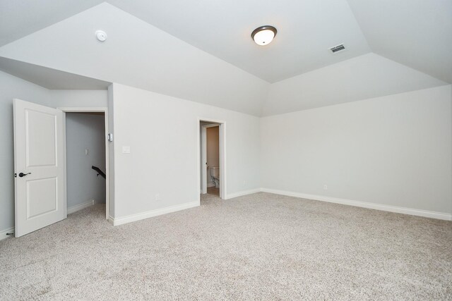 carpeted living room featuring vaulted ceiling