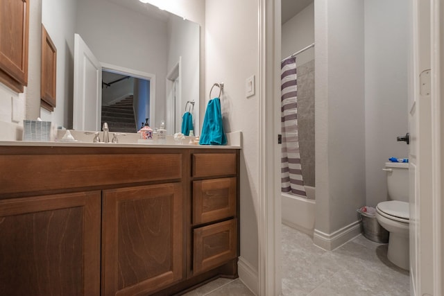 full bathroom with tile patterned floors, shower / bathtub combination with curtain, vanity, and toilet