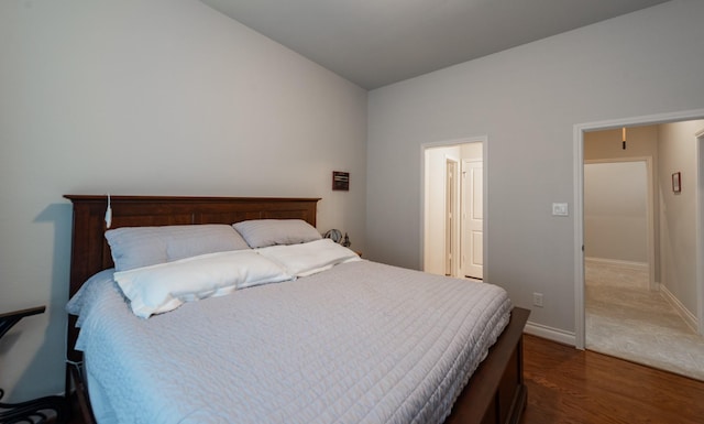 bedroom with wood-type flooring and lofted ceiling