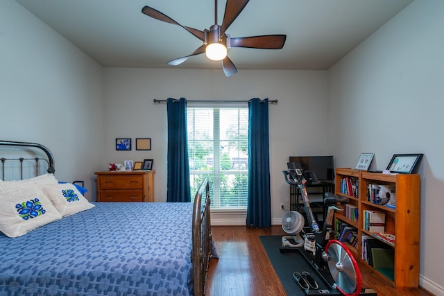 bedroom with ceiling fan and dark hardwood / wood-style flooring