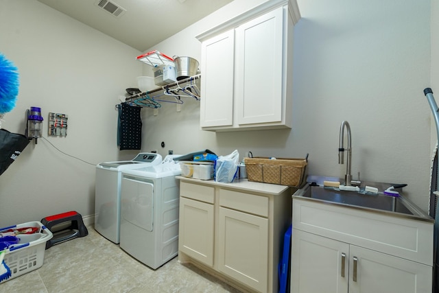 laundry room featuring cabinets, washer and dryer, and sink