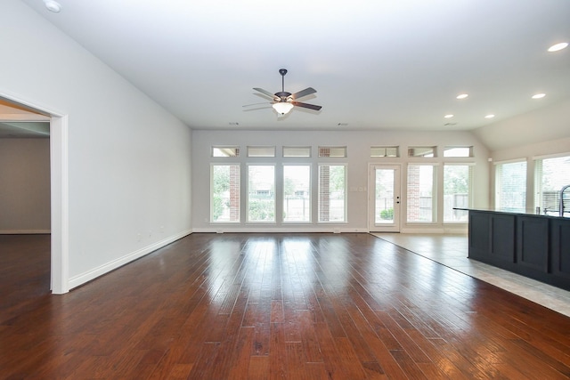 unfurnished living room with ceiling fan, recessed lighting, baseboards, and dark wood finished floors
