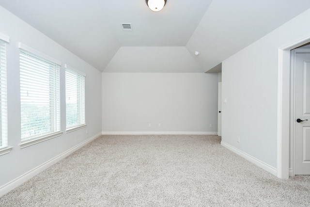 bonus room with baseboards, vaulted ceiling, visible vents, and carpet floors