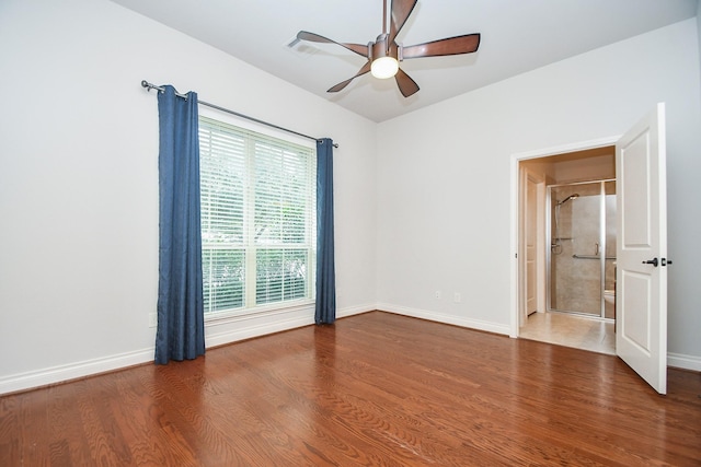 unfurnished bedroom with wood finished floors, baseboards, and a ceiling fan