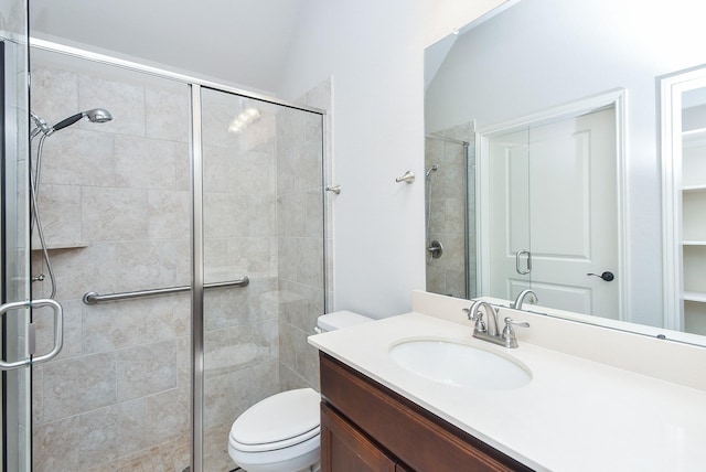 full bathroom with toilet, a stall shower, and vanity