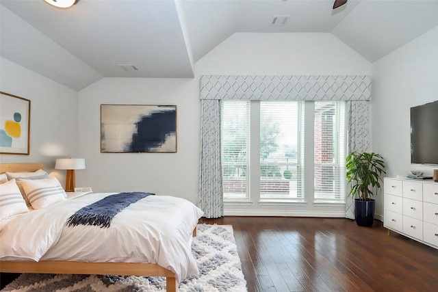 bedroom with visible vents, vaulted ceiling, and dark wood finished floors
