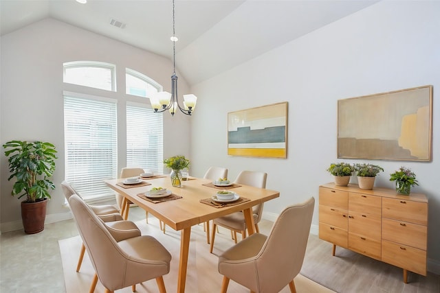 dining space with visible vents, baseboards, a chandelier, and lofted ceiling