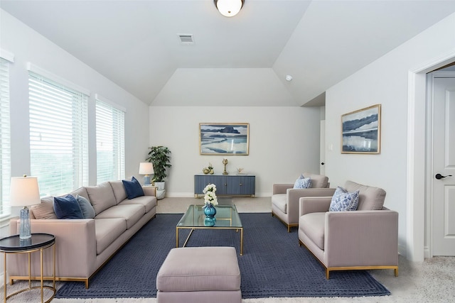 carpeted living room featuring baseboards, vaulted ceiling, and visible vents