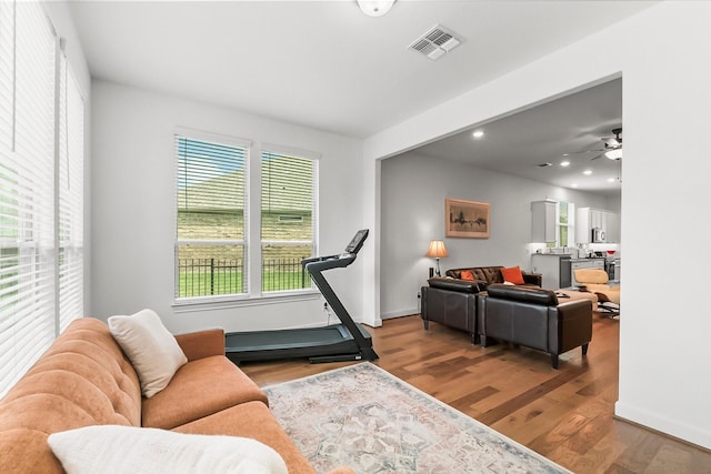 living room featuring hardwood / wood-style floors and ceiling fan