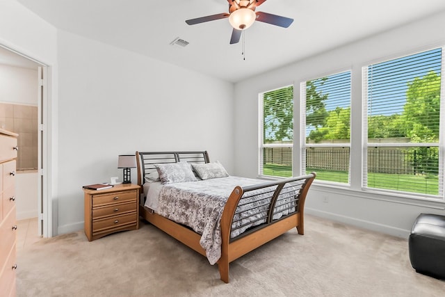 carpeted bedroom with ceiling fan and connected bathroom