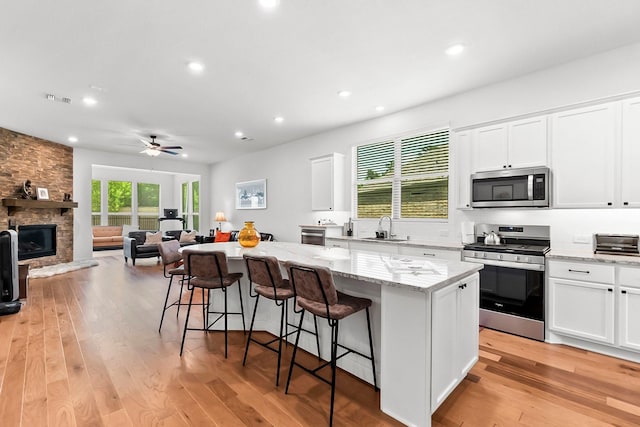 kitchen featuring white cabinets, stainless steel appliances, and a kitchen island