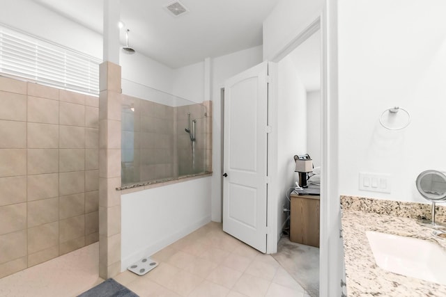 bathroom featuring vanity and tiled shower