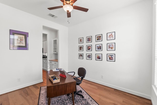 office featuring light wood-type flooring and ceiling fan