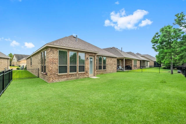 back of house with a lawn