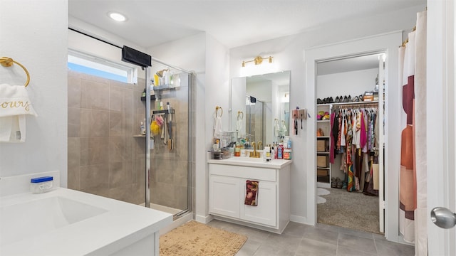 bathroom featuring tile patterned flooring, vanity, and an enclosed shower