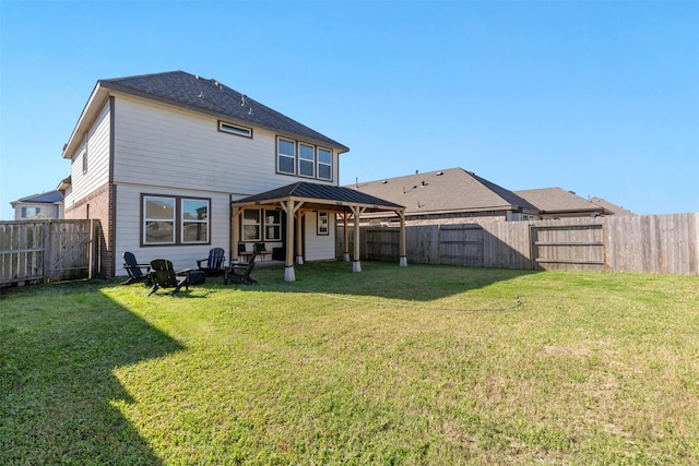 rear view of house with a lawn