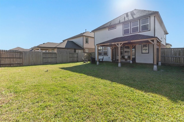 rear view of property with a lawn