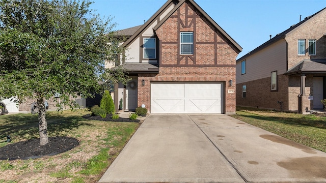 view of front of home with a front yard and a garage