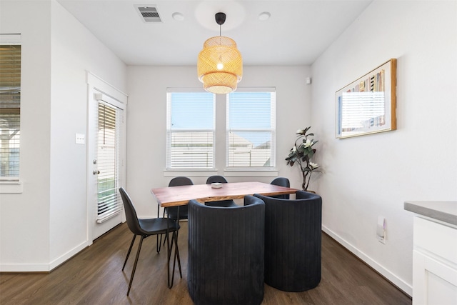 dining space featuring a healthy amount of sunlight and dark hardwood / wood-style floors