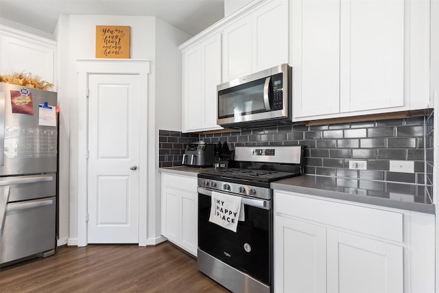 kitchen featuring white cabinets, decorative backsplash, stainless steel appliances, and dark wood-type flooring