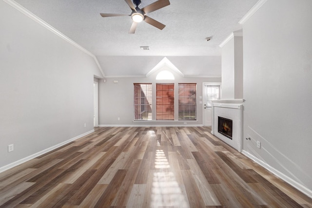 unfurnished living room featuring ornamental molding, a textured ceiling, ceiling fan, hardwood / wood-style floors, and lofted ceiling