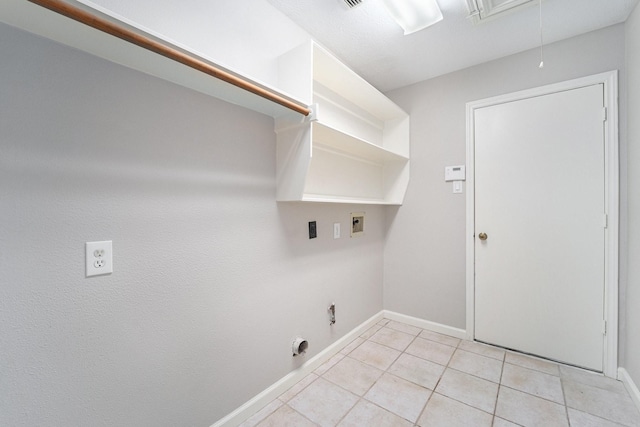 washroom with hookup for an electric dryer, washer hookup, light tile patterned floors, and gas dryer hookup