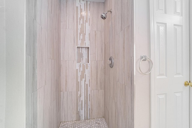 bathroom with tiled shower