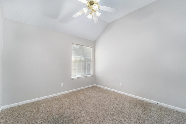 carpeted spare room with vaulted ceiling and ceiling fan