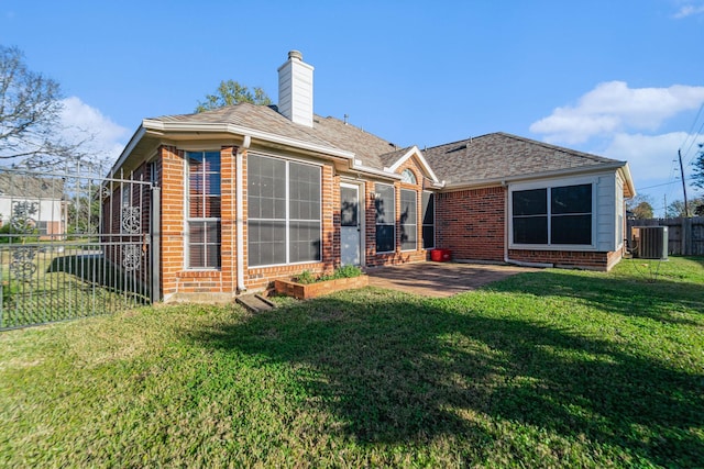 rear view of property featuring a patio area, a yard, and cooling unit