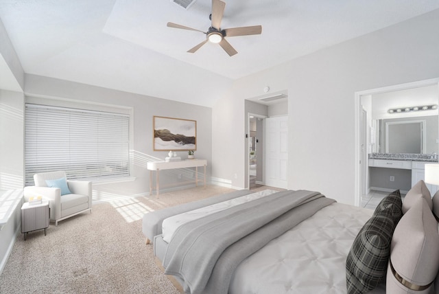 bedroom featuring ceiling fan, lofted ceiling, light carpet, and connected bathroom