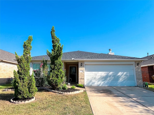 single story home featuring a garage and a front lawn