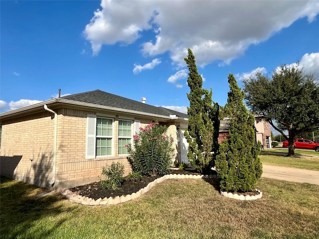 view of side of home featuring a yard