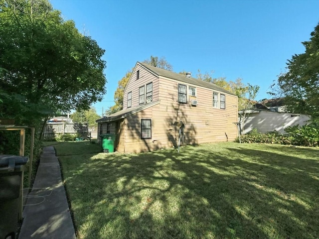 rear view of house with a yard