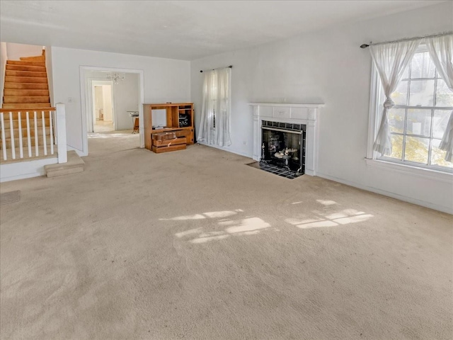 unfurnished living room featuring a fireplace and light carpet