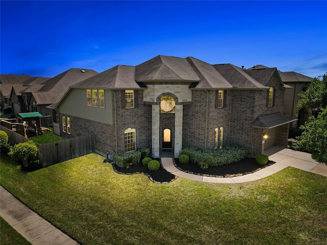 view of front of property featuring a garage and a front yard