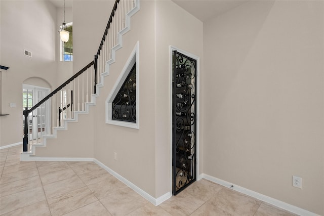 staircase featuring a high ceiling