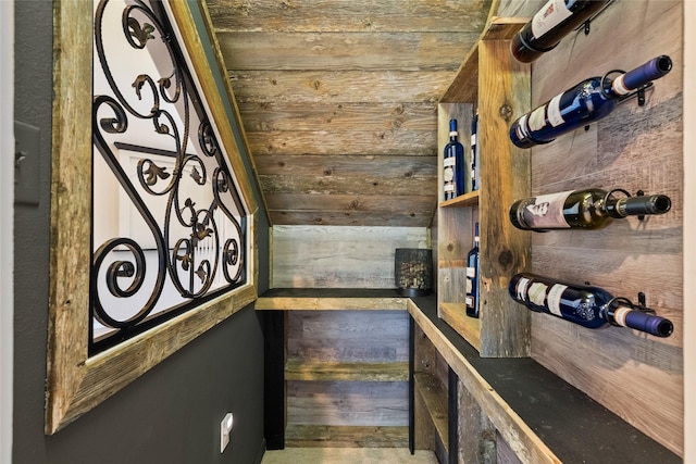 wine area featuring wood walls