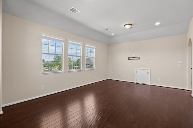 unfurnished room with dark hardwood / wood-style flooring