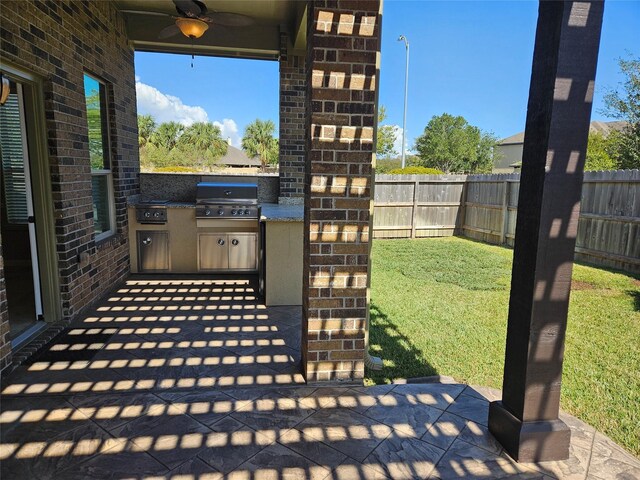 view of patio featuring area for grilling and ceiling fan