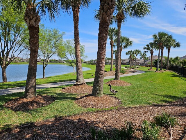 surrounding community featuring a yard and a water view