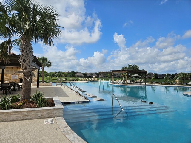 view of pool featuring a pergola and a patio