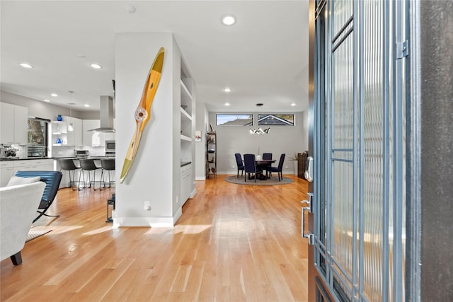 entrance foyer featuring plenty of natural light and light hardwood / wood-style flooring