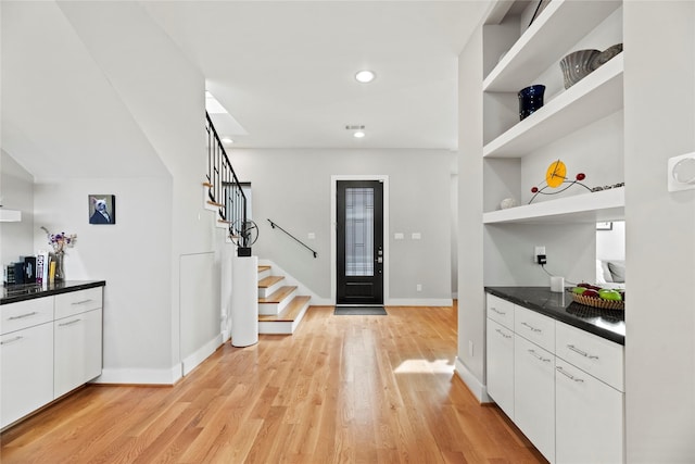 bar featuring white cabinets and light wood-type flooring