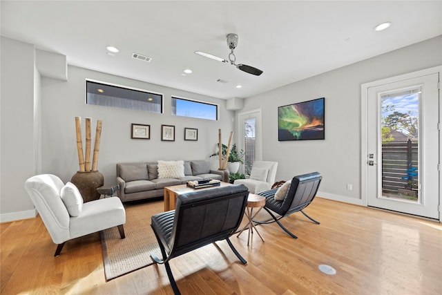 living room with ceiling fan and light hardwood / wood-style floors