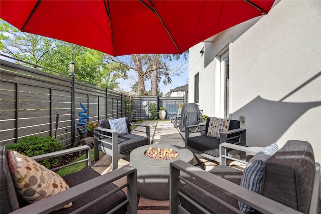 view of patio featuring an outdoor living space with a fire pit