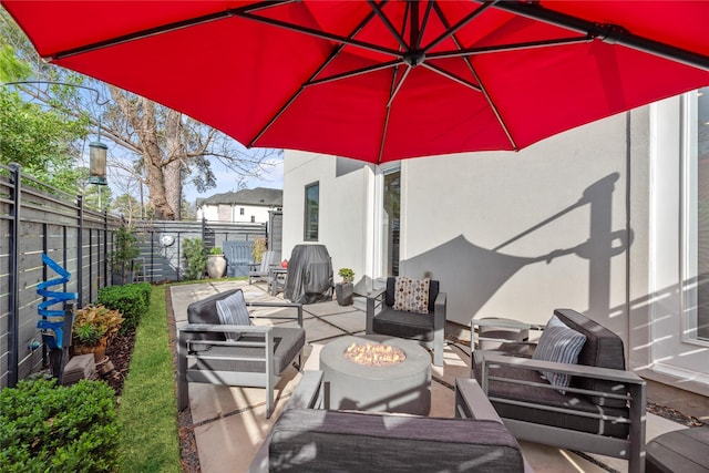 view of patio featuring an outdoor living space with a fire pit