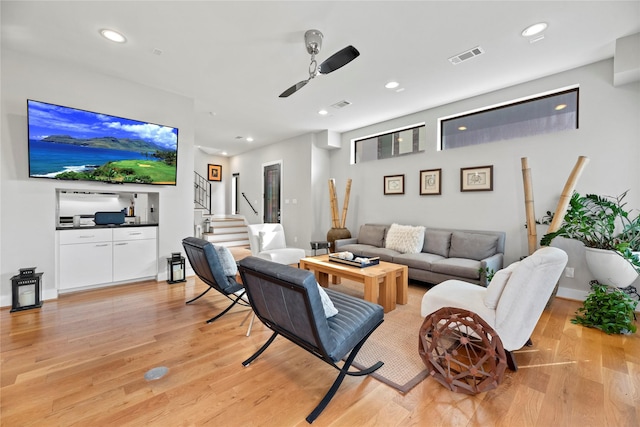 living room with ceiling fan and light wood-type flooring