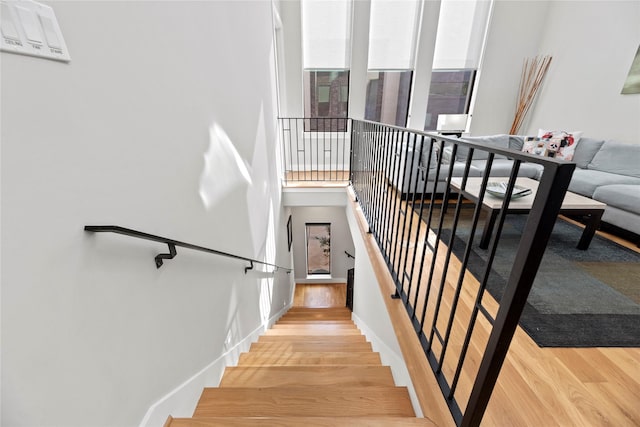 staircase with hardwood / wood-style flooring