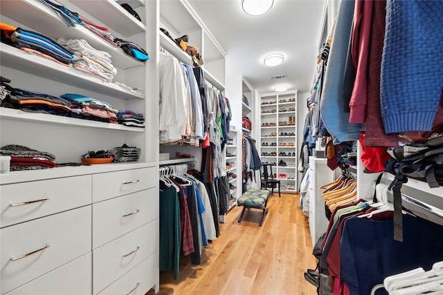 walk in closet with light wood-type flooring